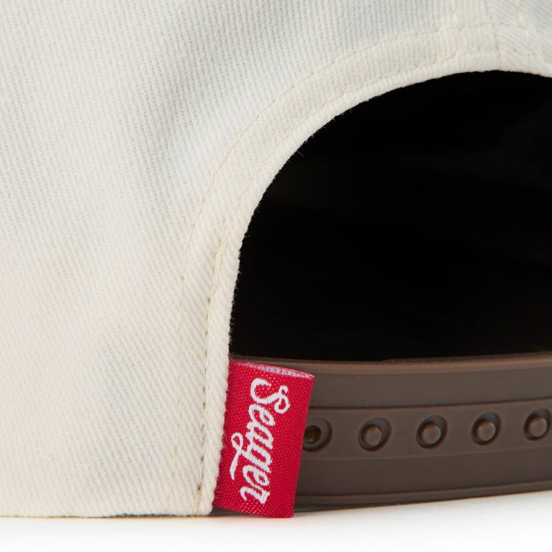 Close-up of a cap with a red Seager logo tag on a white background
