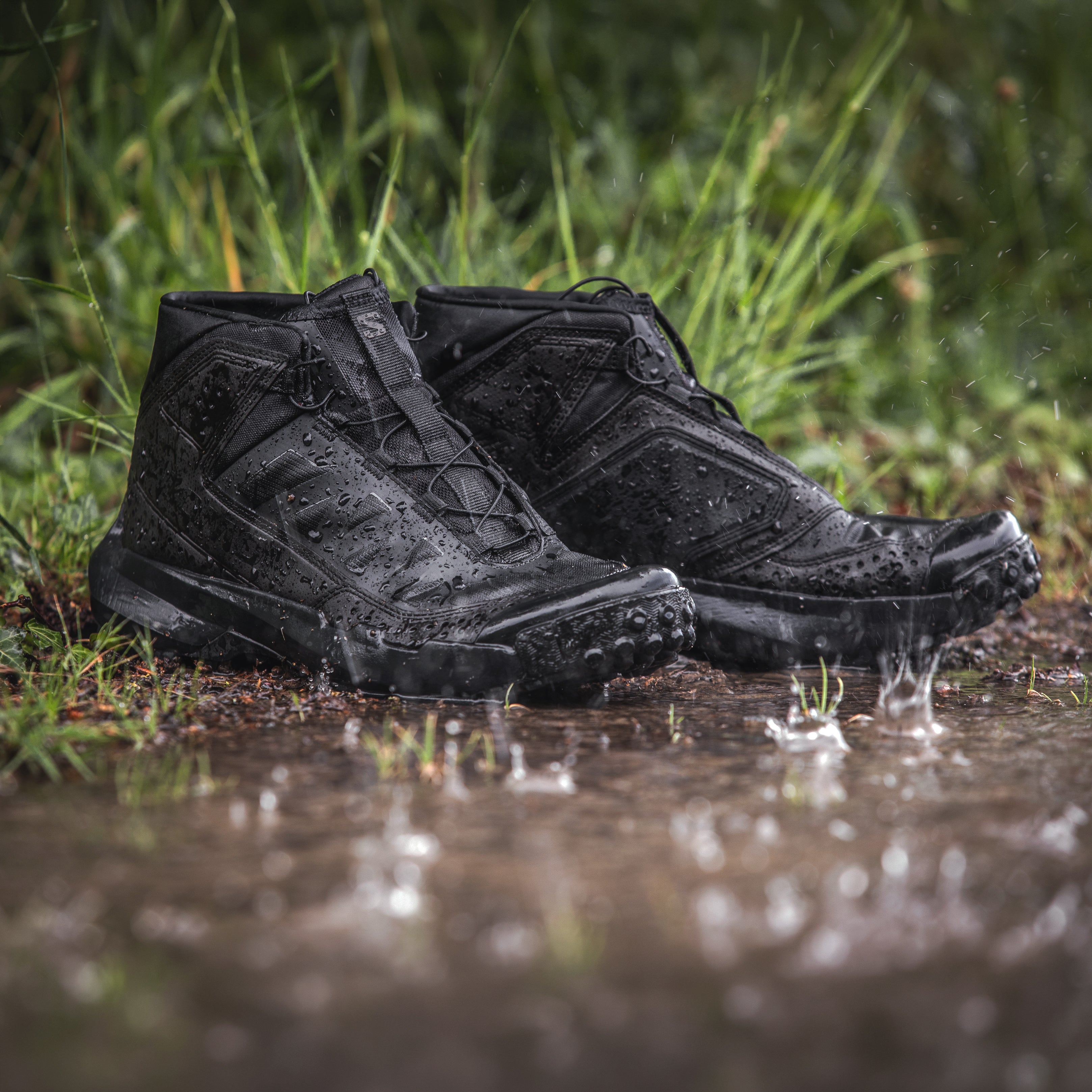 Salomon FORCES Amphib Assault amphibious tactical shoes sitting in shallow water during maritime training, fast drying water operations footwear with Matryx Kevlar upper, drain zones, and Contagrip outsole built for combat swimmer and shoreline infiltration missions