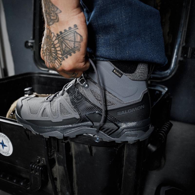 On body view of the Salomon FORCES X Ultra Mid boots being worn showing the lightweight tactical design, Advanced Chassis stability, and All Terrain Contagrip traction built for military operations, law enforcement duty, mountain trekking, and rugged outdoor missions.