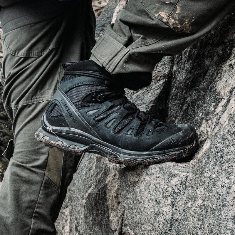 Salomon Quest 4D Forces 2 Boots worn in rugged outdoor terrain, demonstrating stability and support during demanding movement.