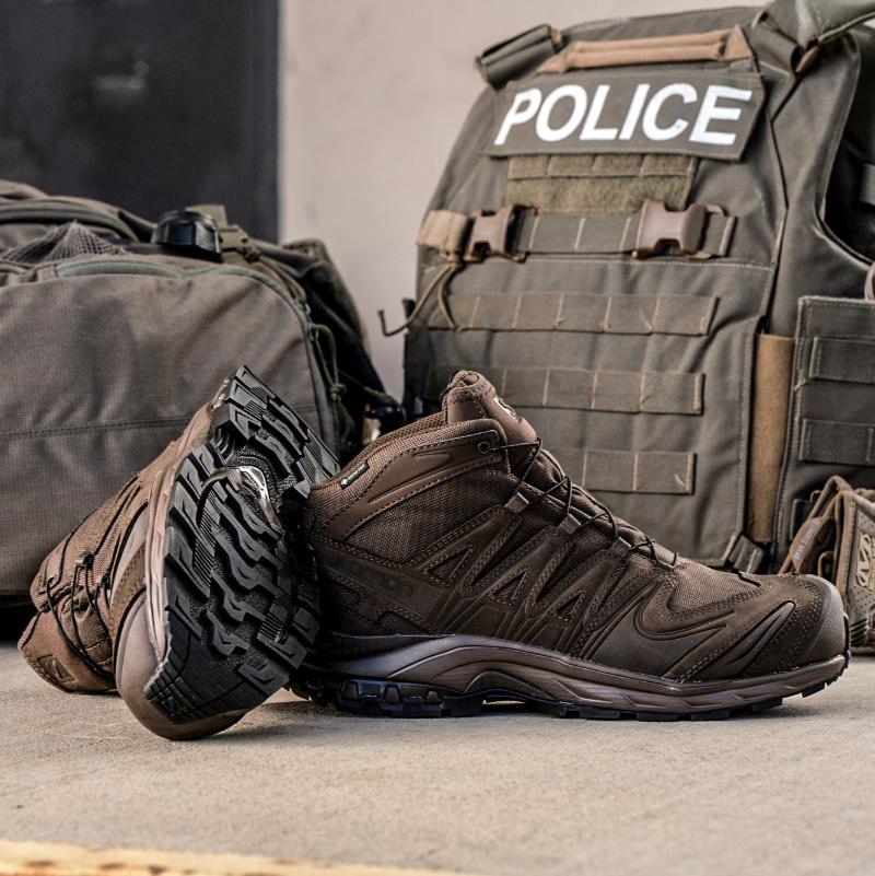 Salomon XA FORCES MID Earth Brown tactical boots shown with tactical gear and kit | Lightweight military combat footwear with Quicklace system reinforced mid chassis and rugged outsole built for law enforcement patrol and all terrain operations