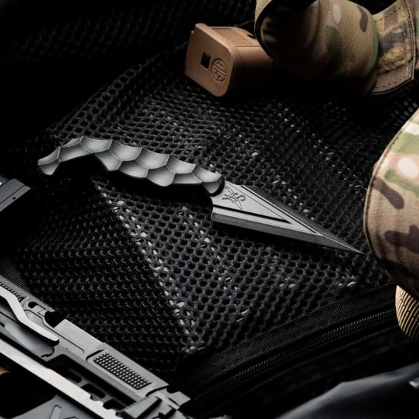 Lifestyle flat lay of the Stroup Knives Ultralite Non-Metallic Knife in Black, arranged with everyday carry gear to highlight its lightweight one-piece Zytel construction, fully non-metallic design, and discreet Kydex sheath setup ideal for low-profile defensive carry.