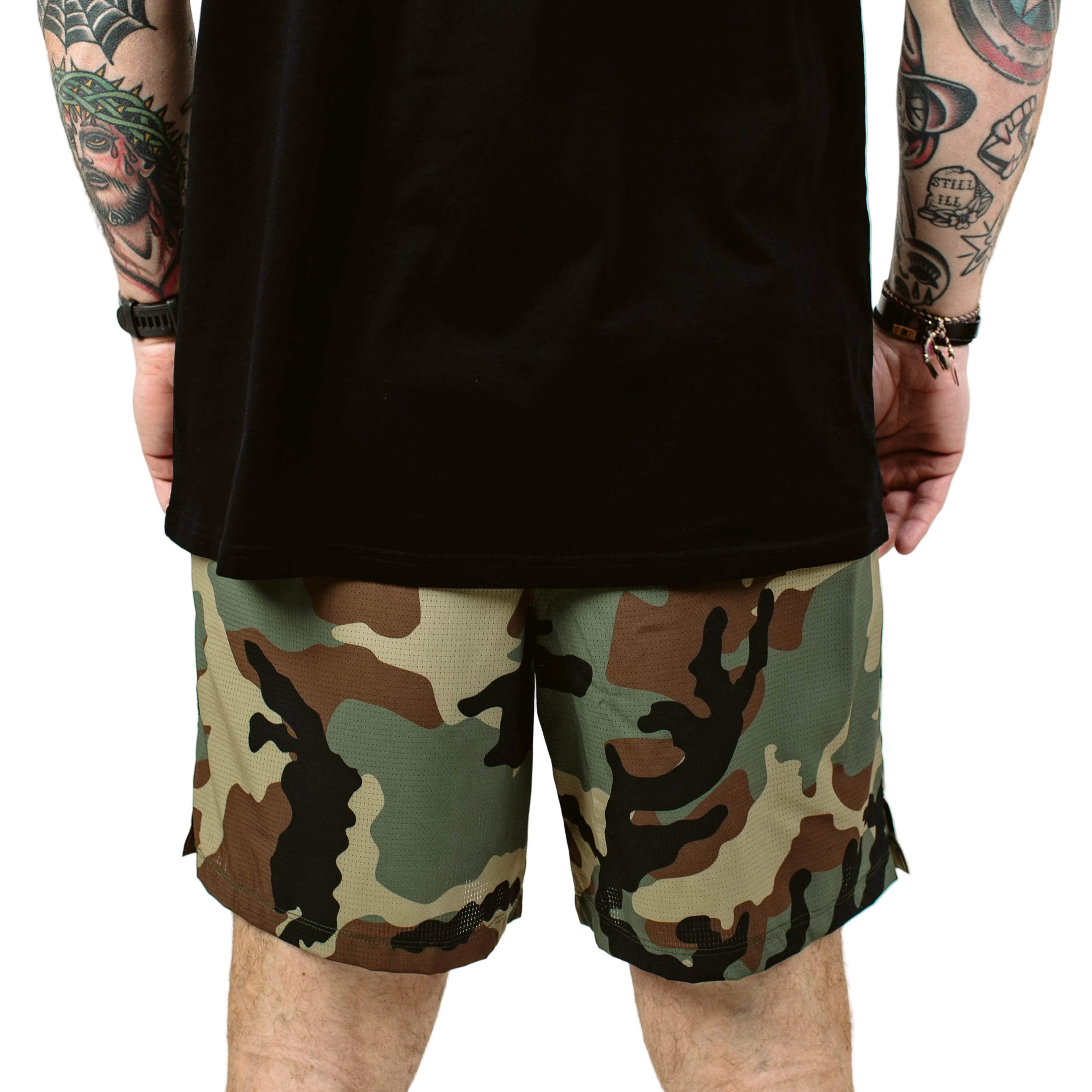 TD Contender Training Shorts in Woodland camo worn from the back during training, lightweight tactical performance shorts with 7 inch inseam, secure zip pocket, and quick dry stretch fabric built for rucking and high output workouts