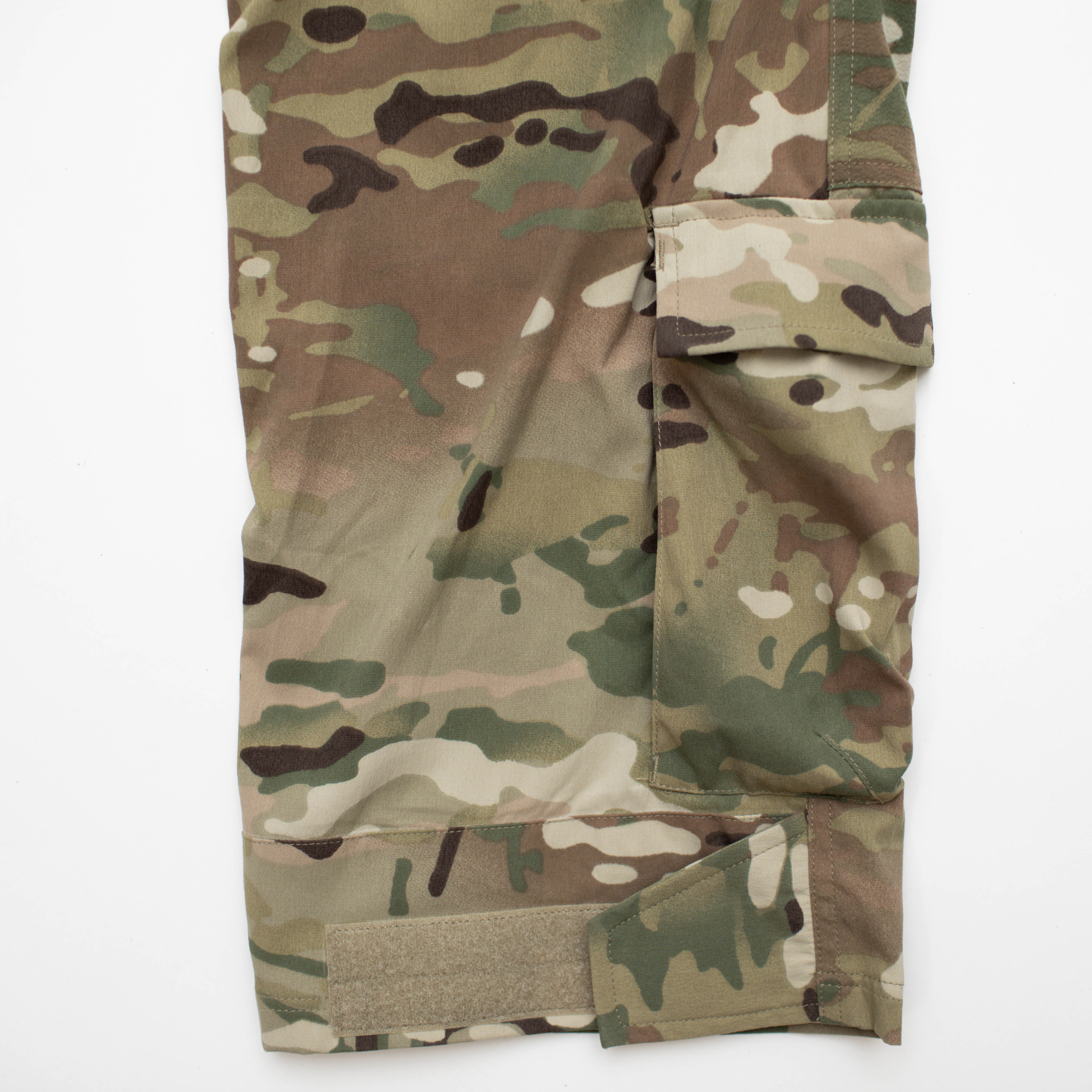 Close-up of TD Cordell Amphib Combat Pants V2 in MultiCam® Agility showing improved hook-and-loop Velcro strap adjustments and reinforced ankle cargo pocket sized for a tourniquet or first aid gear. Amphibious tactical pants built with Brookwood quick-dry fabric for EDC, range training, and field deployments.