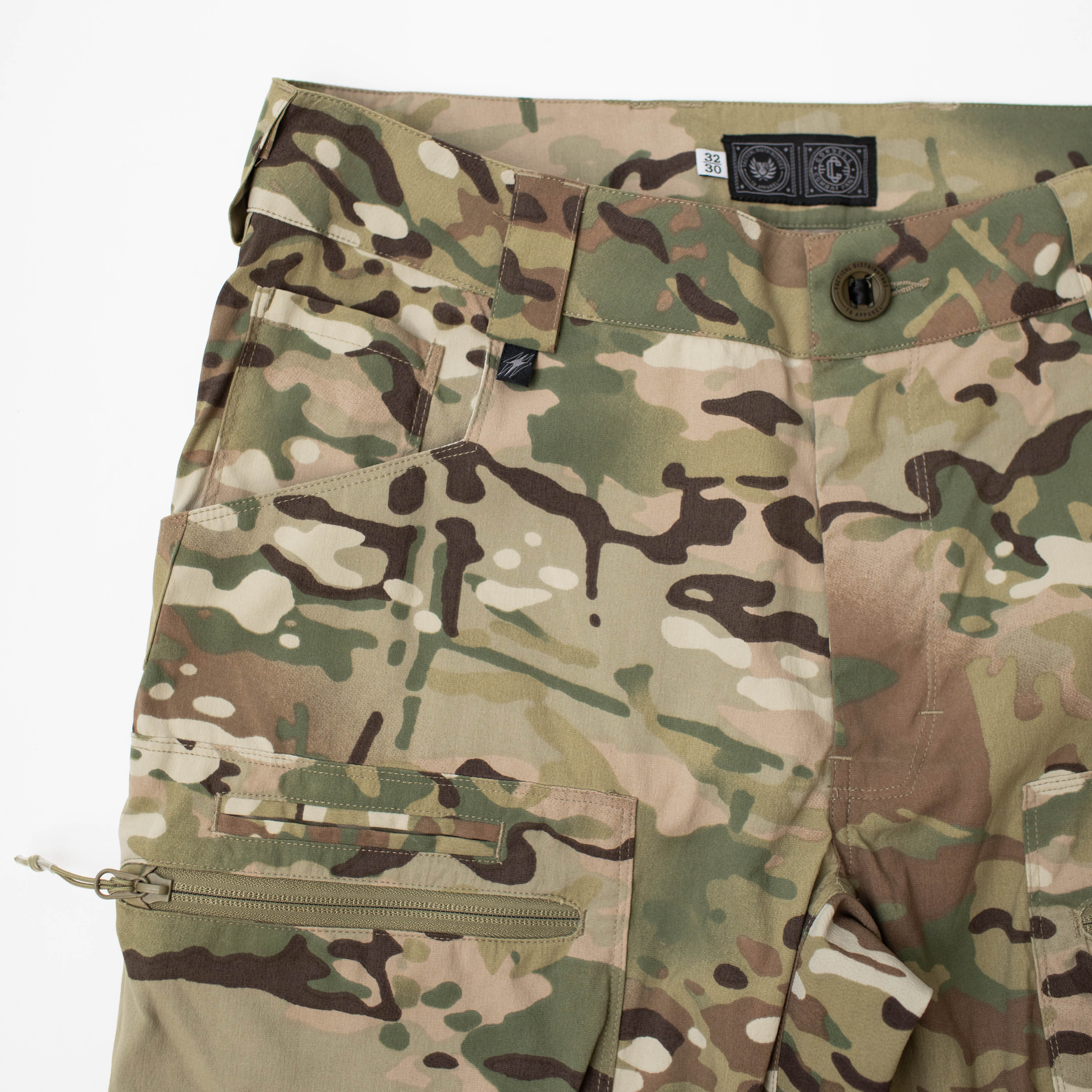 Detail view of TD Cordell Amphib Tactical Combat Pants V2 in MultiCam® Agility showing multiple front pockets, including reinforced hand pockets, coin pockets for pistol mags, and zippered cargo storage. Amphibious combat pants built for EDC, range work, and field missions with quick-dry, abrasion-resistant Brookwood fabric.