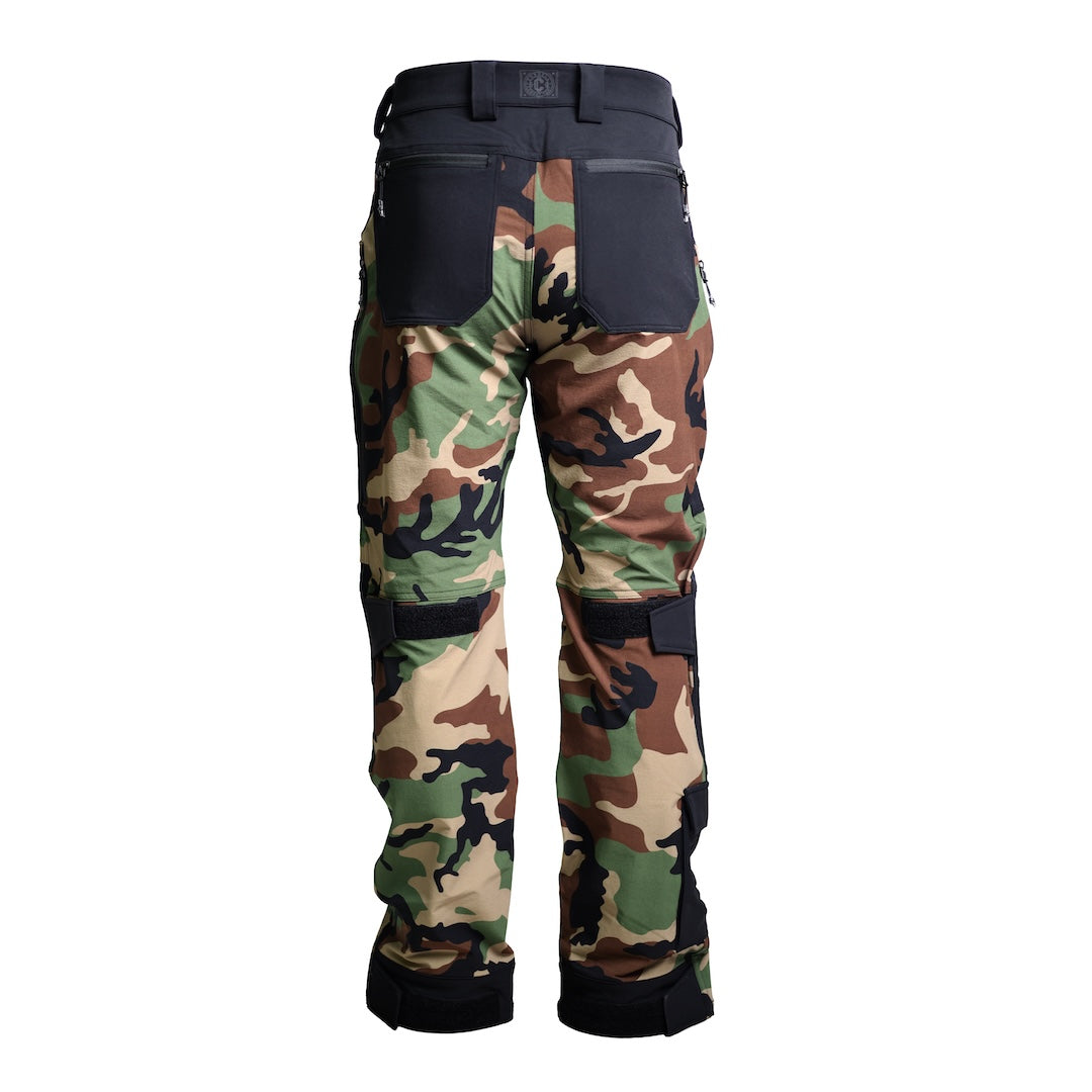 Back view of the TD Cordell Combat Pants V2 in the Colorblocked M81 Woodland and Black version, highlighting the reinforced heel panels, articulated leg design, durable double-weave softshell fabric, and wide belt loops. Shows rear zip pockets, ergonomic back yoke, and multi-panel construction blending M81 Woodland camo with black reinforcement zones. Ideal for users searching for tactical combat pants with reinforced durability, M81 Woodland colorblocked styling, and multi-season EDC performance.