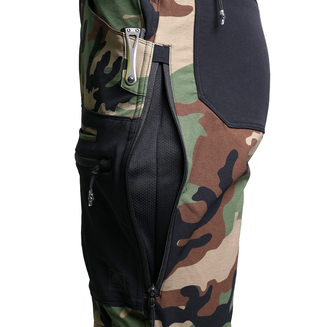 Close-up detail of the TD Cordell Combat Pants V2 in the Colorblocked M81 Woodland and Black version showing the mesh-backed side vent unzipped and the adjacent cargo and mag pocket layout. Highlights the ventilation system for heat dumping, reinforced softshell construction, and quick-access EDC pocket configuration. Ideal for users searching for ventilated M81 Woodland combat pants, colorblocked tactical pants with functional storage, and high-mobility fieldwear engineered for training and operational use