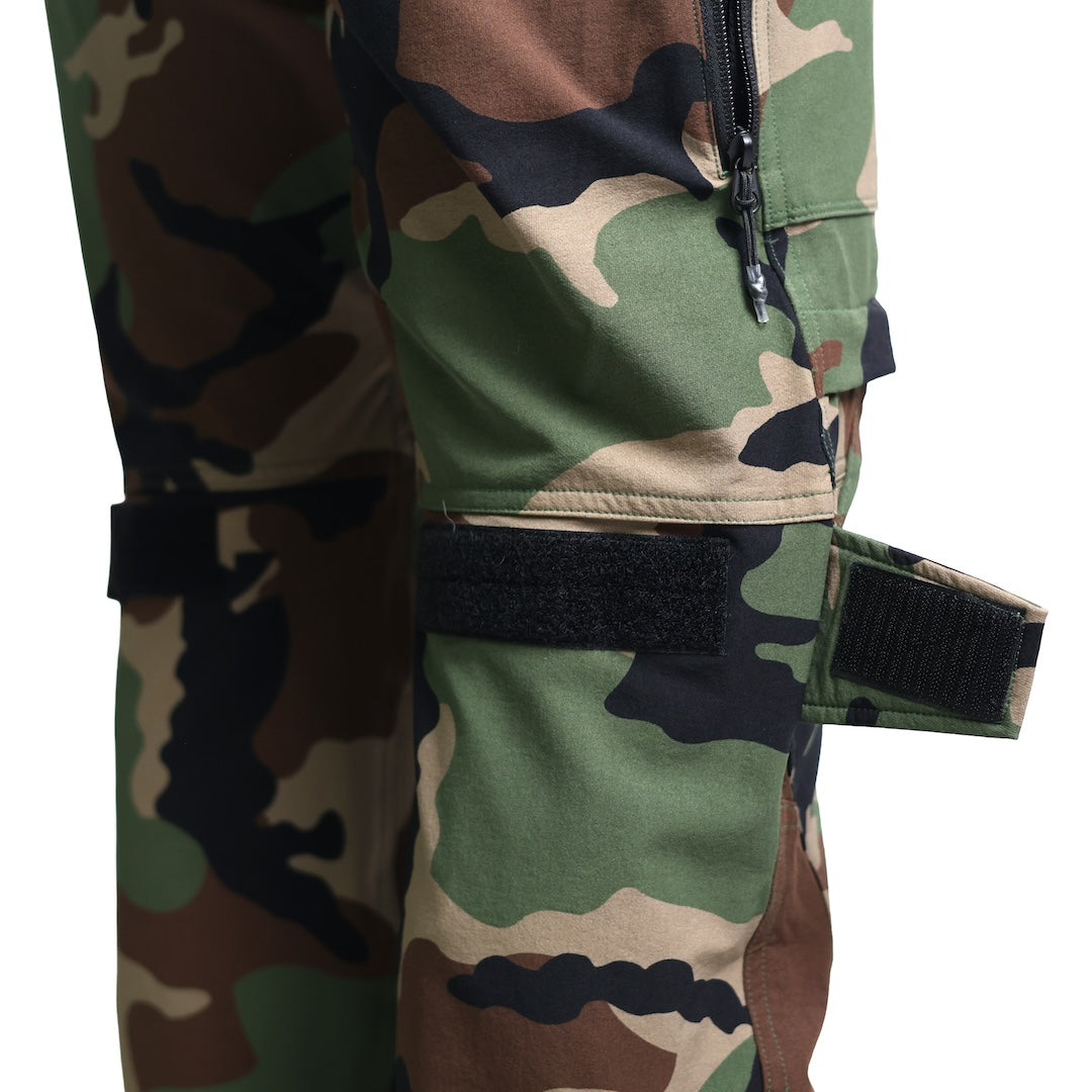 Close-up showing the TD Cordell Combat Pants V2 in M81 Woodland with the knee adjustment strap being used. Highlights the upgraded hook-and-loop tightening system designed to secure knee pads, refine fit, and improve stability during movement. Ideal for users searching for M81 Woodland combat pants with knee adjustment features, customizable tactical fit, and enhanced mobility for range days and field operations.