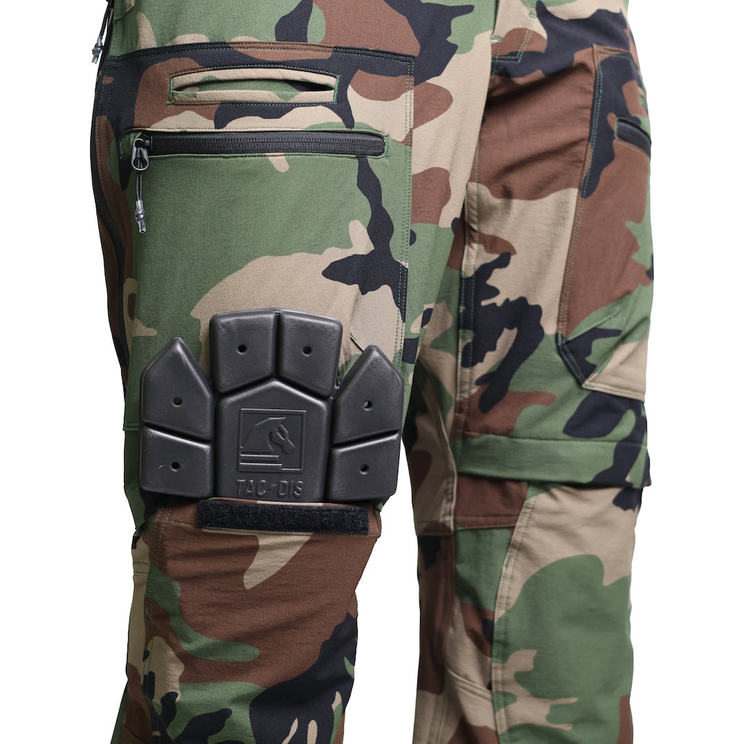 Close-up showing a knee pad being inserted into the TD Cordell Combat Pants V2 knee pad pocket in the M81 Woodland colorway. Highlights the reinforced knee panel design, internal knee pad compatibility, and ergonomic shaping built for tactical movement, field work, and range training. Ideal for users searching for combat pants with knee pad pockets, impact-ready EDC pants, or modular tactical trousers.