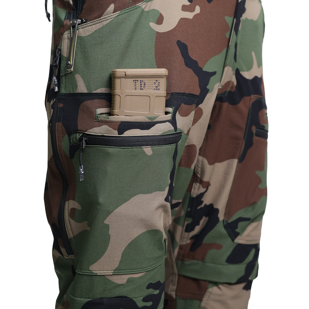 Close-up of the TD Cordell Combat Pants V2 in M81 Woodland with an AR magazine inserted into the side mag pocket, showing the secure welted design and quick-access placement. Highlights the combat-ready pocket layout optimized for EDC, range training, and tactical mobility. Ideal for users searching for M81 Woodland pants with AR mag pockets, fast-access storage, and mission-driven functionality.