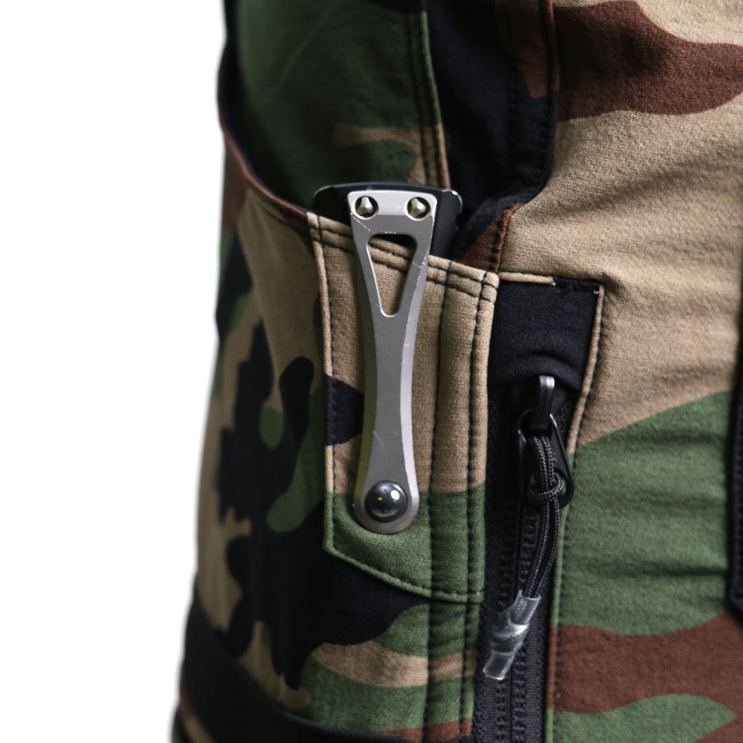 Alternate close-up angle of the TD Cordell Combat Pants V2 in M81 Woodland highlighting the reinforced front pocket panel designed for knife clips and everyday carry tools. Shows the abrasion-resistant overlay, precise stitching, and durable softshell fabric built for hard-use environments. Ideal for users searching for tactical pants with reinforced EDC pockets, knife-compatible front pocket design, and long-lasting combat-ready construction.