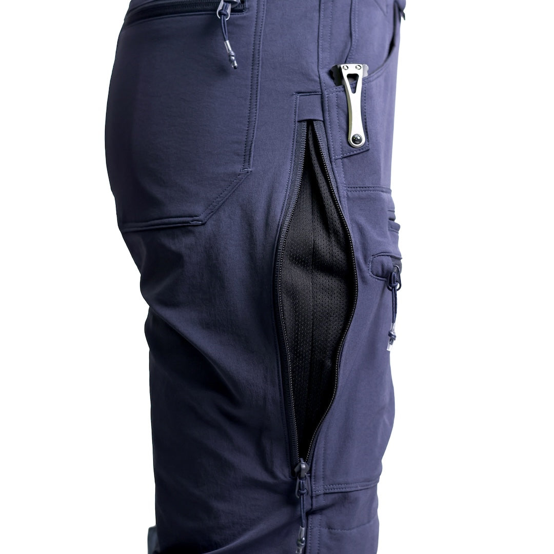 Close-up of the TD Cordell Combat Pants V2 in Navy Blue with the mesh-backed side vent unzipped, showing the heat-dump ventilation system designed for high-output movement. Highlights the softshell fabric, articulated leg construction, and breathable EDC-oriented design. Ideal for users searching for navy tactical pants with ventilation, breathable combat pants for training, or performance trousers built for warm-weather field use.