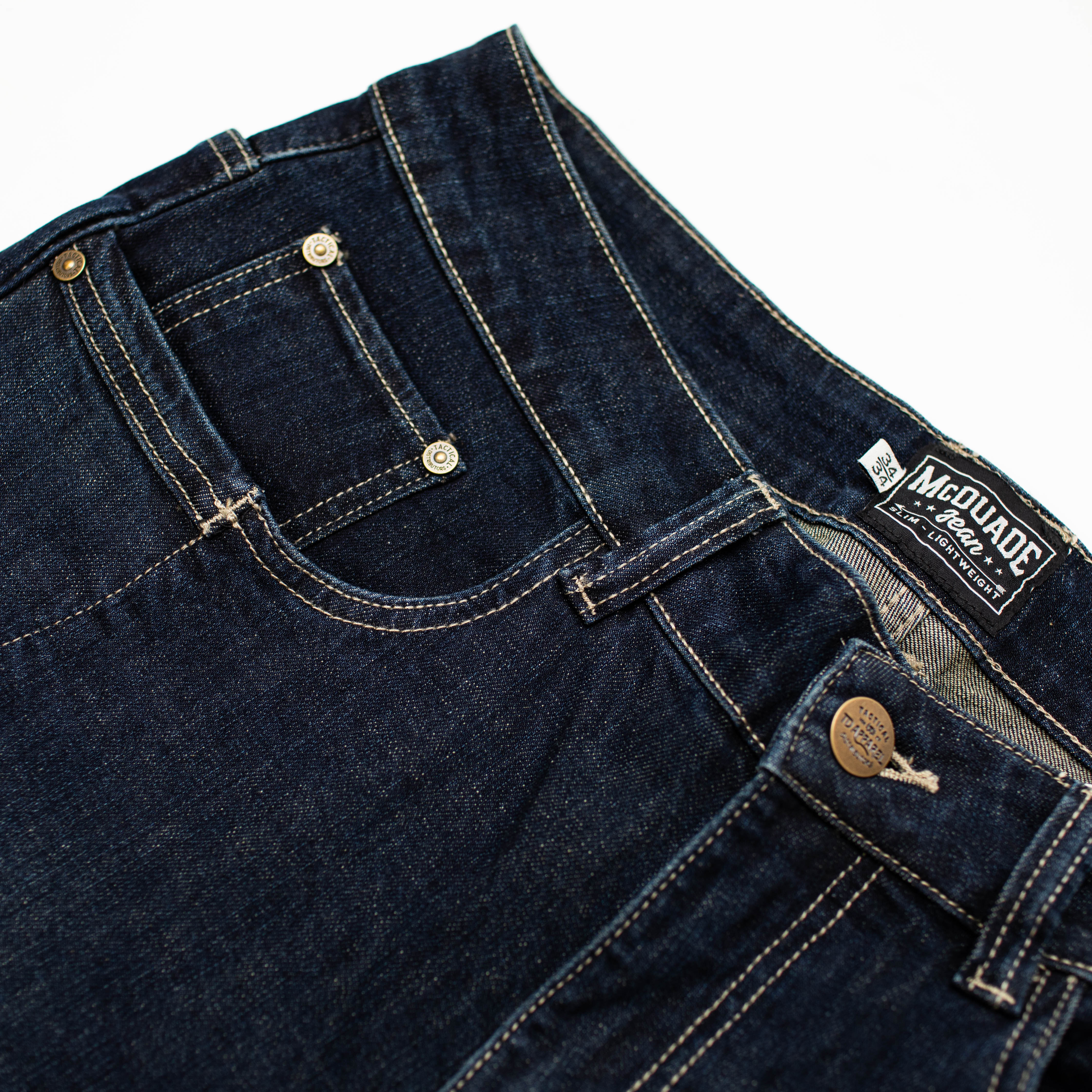 Close view of the TD McQuade Tactical Jeans in Deep Sea slim cut showing the reinforced waistband construction, heavy-duty stitching, and EDC optimized pocket layout designed for concealed carry and everyday tactical use.
