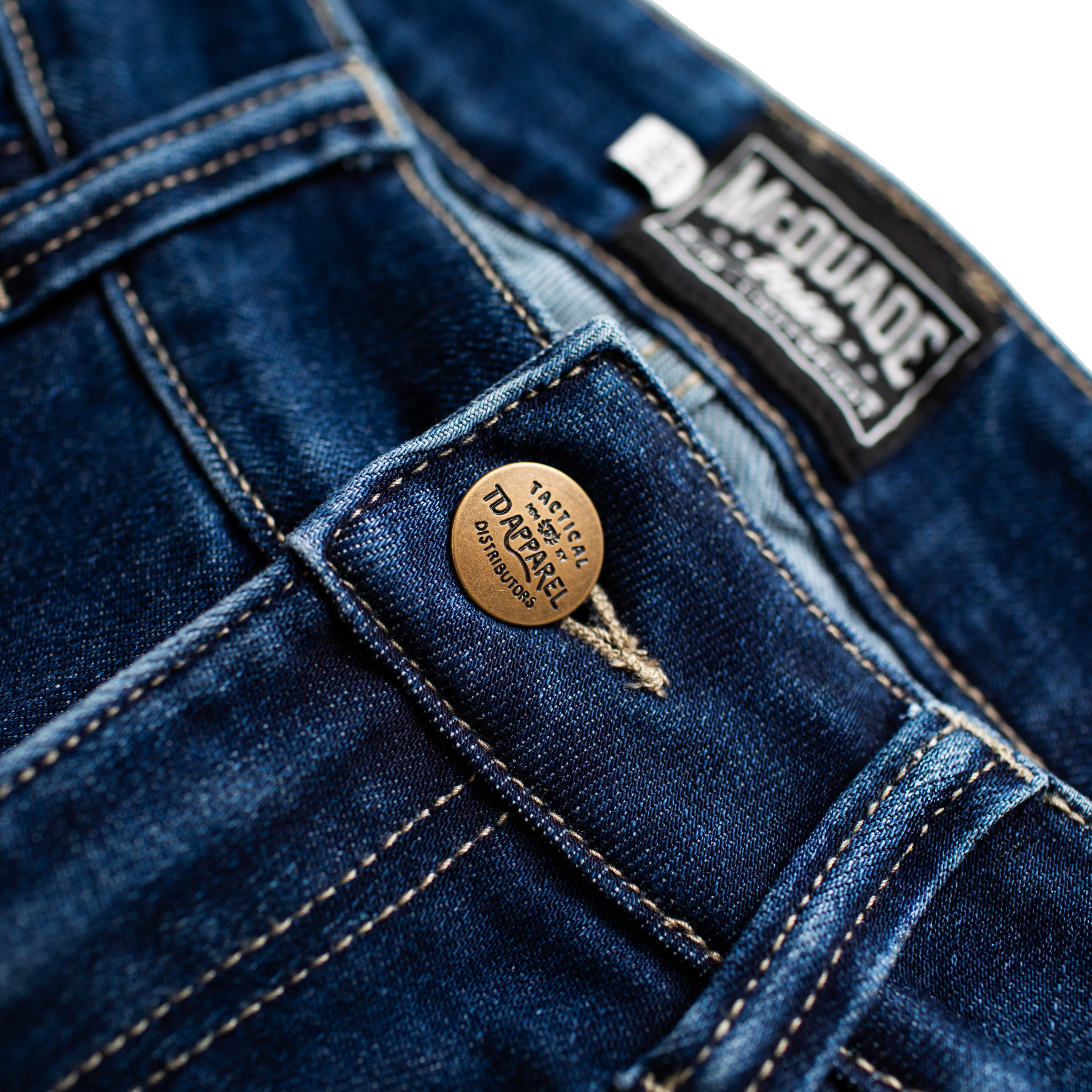Close up of the TD McQuade Tactical Jeans in the Vintage wash showing the reinforced waistband, branded shank button, heavy duty stitching, and concealed carry friendly tactical denim construction designed for users searching for the best tactical jeans, CCW pants, and everyday carry denim.