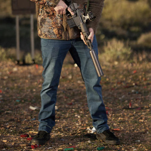 Photo demonstrating TD McQuade EDC Tactical Jeans worn at the shooting range and for everyday carry, highlighting tactical nine-pocket layout, stretch denim comfort, and concealed carry versatility for daily and range use
