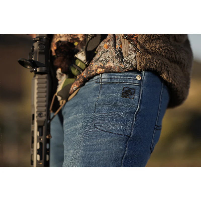 Photo of TD McQuade EDC Tactical Jeans being worn at a shooting range, demonstrating stretch denim, nine-pocket tactical design, and comfortable concealed carry fit for range days and everyday use