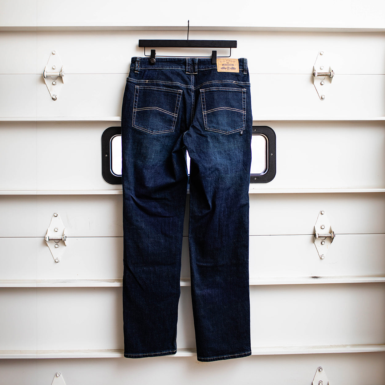 Back view of the TD McQuade Tactical Jeans in Deep Sea wash showing the reinforced rear pockets, AR mag compatible EDC pockets, concealed carry friendly waistband, and durable stretch tactical denim designed for users searching for the best tactical jeans and everyday carry pants.