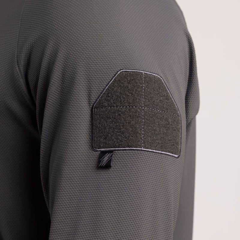 Close-up detail of the TD OSS Operator Shooter Shirt showing the bicep loop field for attaching patches, unit ID, or insignia. This tactical feature keeps the shirt low-profile yet fully functional for operators who need customization while maintaining a sleek performance base layer for range or mission use