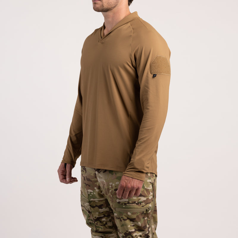 Three-quarter view of TD OSS Operator Shooter Shirt in Coyote Brown highlighting the loop field on the upper arm for patches or unit ID and showcasing the modern shawl collar for neck protection. Built from durable four-way stretch moisture-wicking fabric, this tactical layer is perfect for operators and shooters needing reliable comfort and freedom of movement