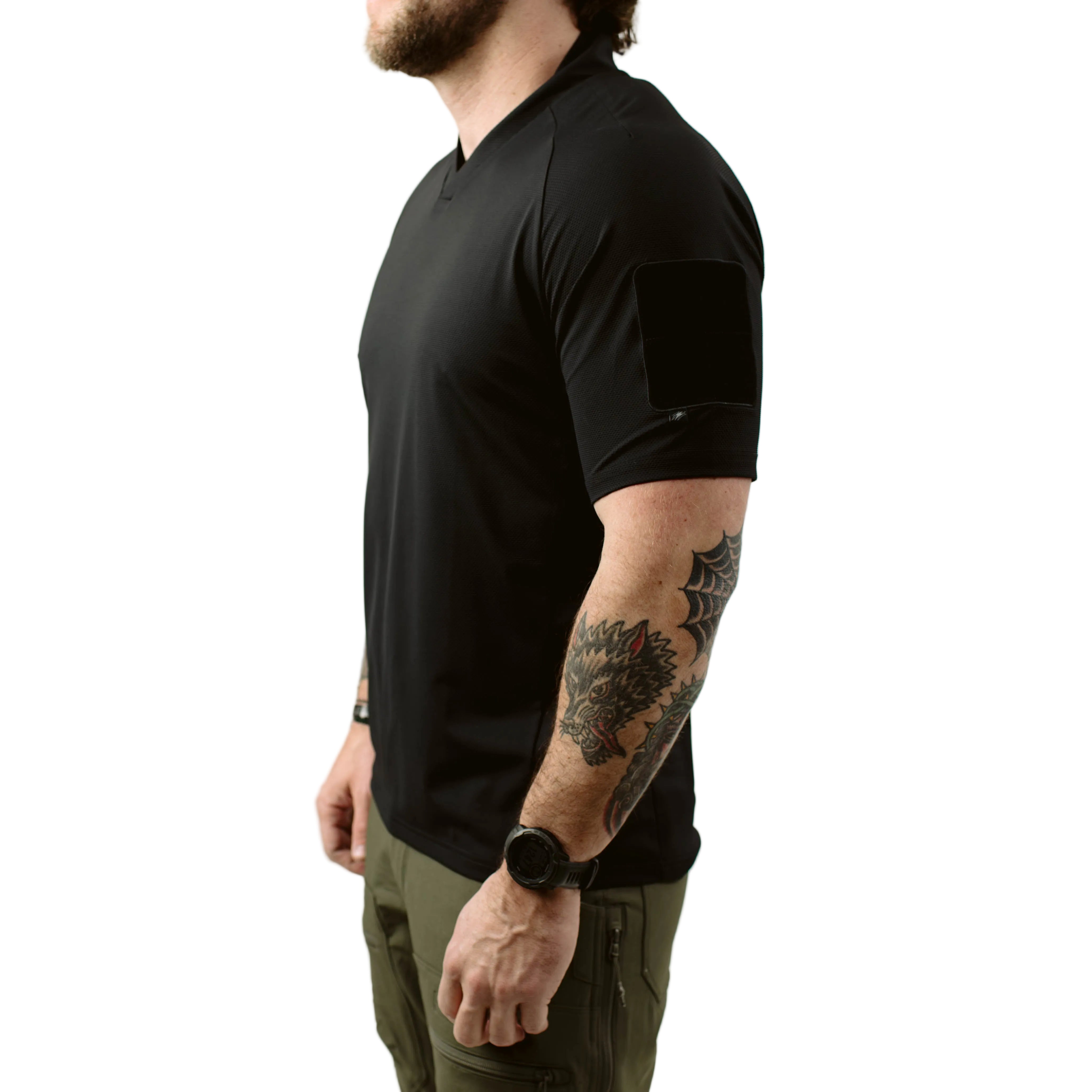 Side view of TD OSS Top Short Sleeve in Black showing athletic combat base layer fit, raglan sleeve articulation, and low profile bicep loop field, lightweight tactical range shirt built for hot weather training, operator use, and duty wear under plate carriers