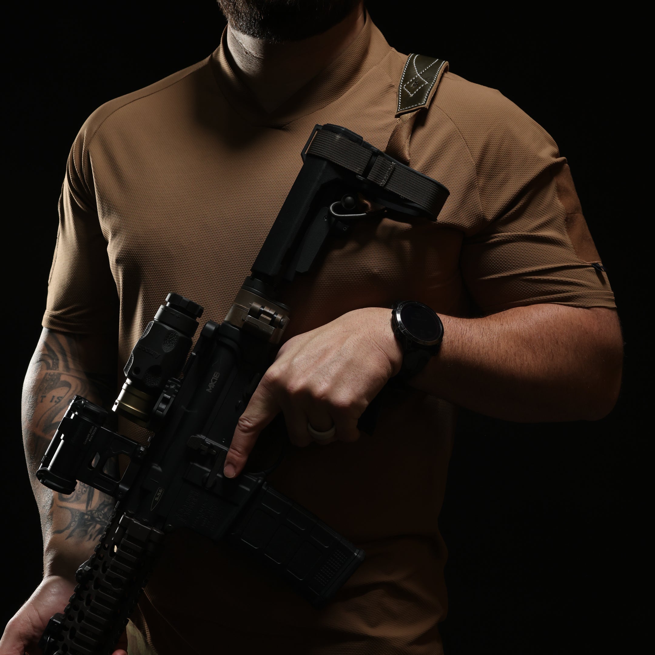 Operator wearing TD OSS Top Short Sleeve in Coyote during live fire training, lightweight tactical range shirt and combat base layer built for hot weather shooter drills, plate carrier setups, and professional duty use in high output environments