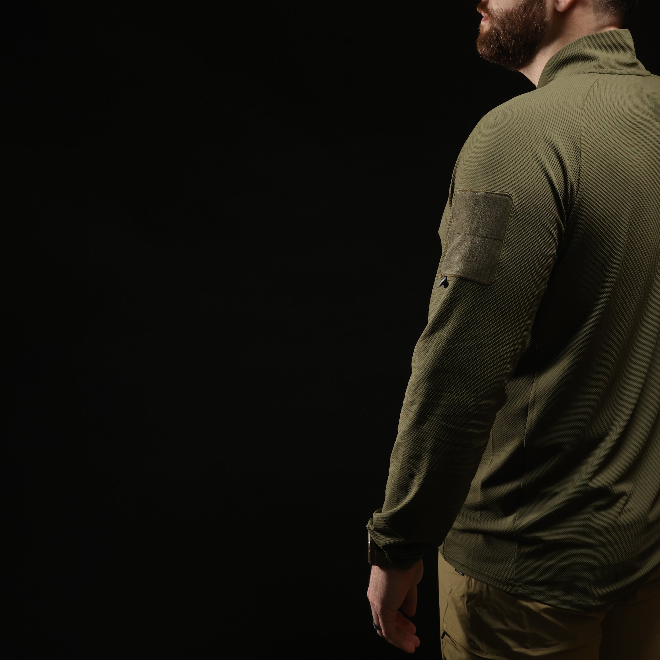 TD OSS Top V2 Long Sleeve in Ranger Green worn in tactical kit showing articulated arm cut, raglan sleeve seams, and athletic combat base layer fit, lightweight operator top and shooter shirt built for range training and duty wear under plate carriers