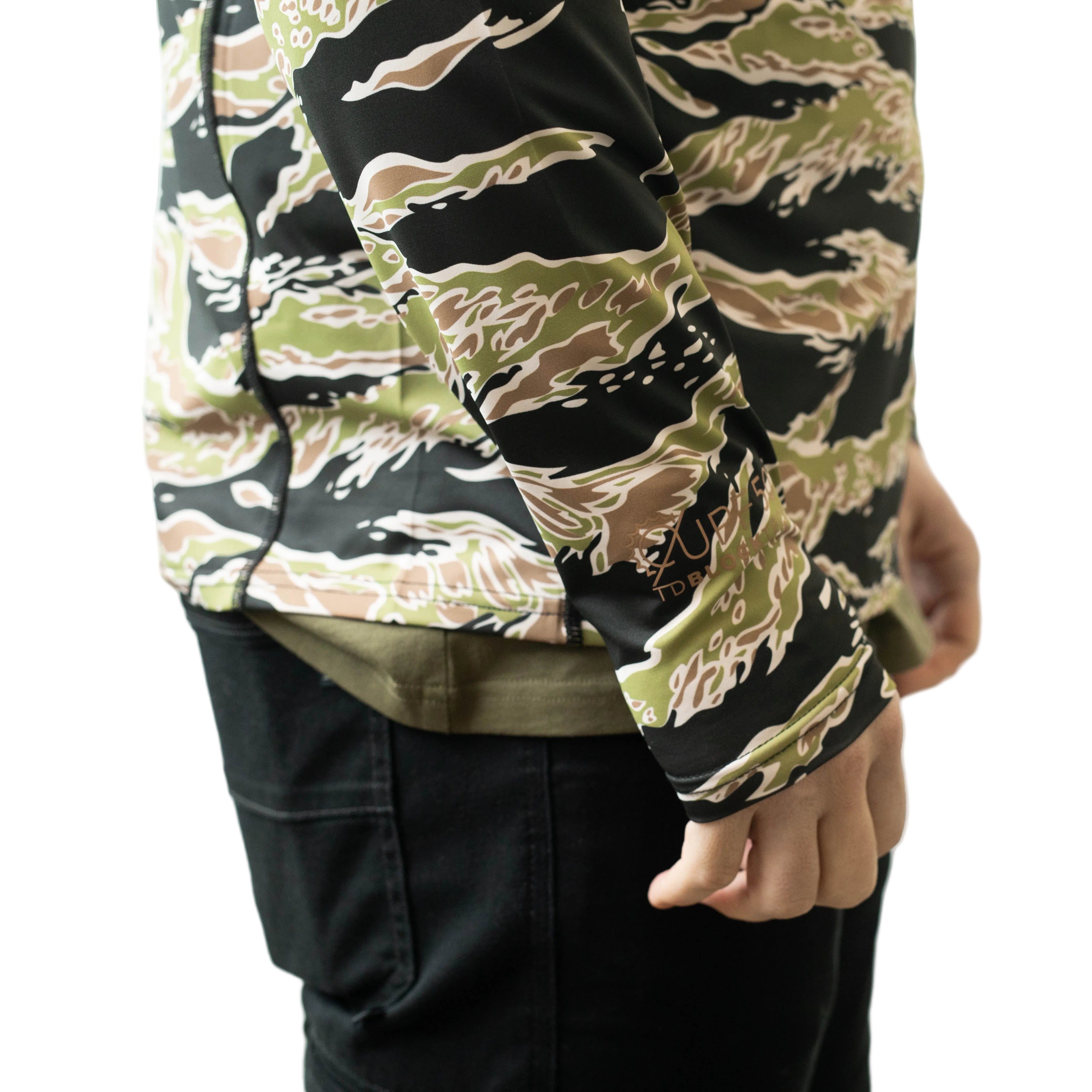 Close up of TD Outdoor Tiger Shark Sun Shirt in Golden Tiger camo showing sleeve construction, tonal flatlock stitching, and hidden thumb loop integration on lightweight UPF 50 tactical sun hoodie built for glove compatible outdoor performance