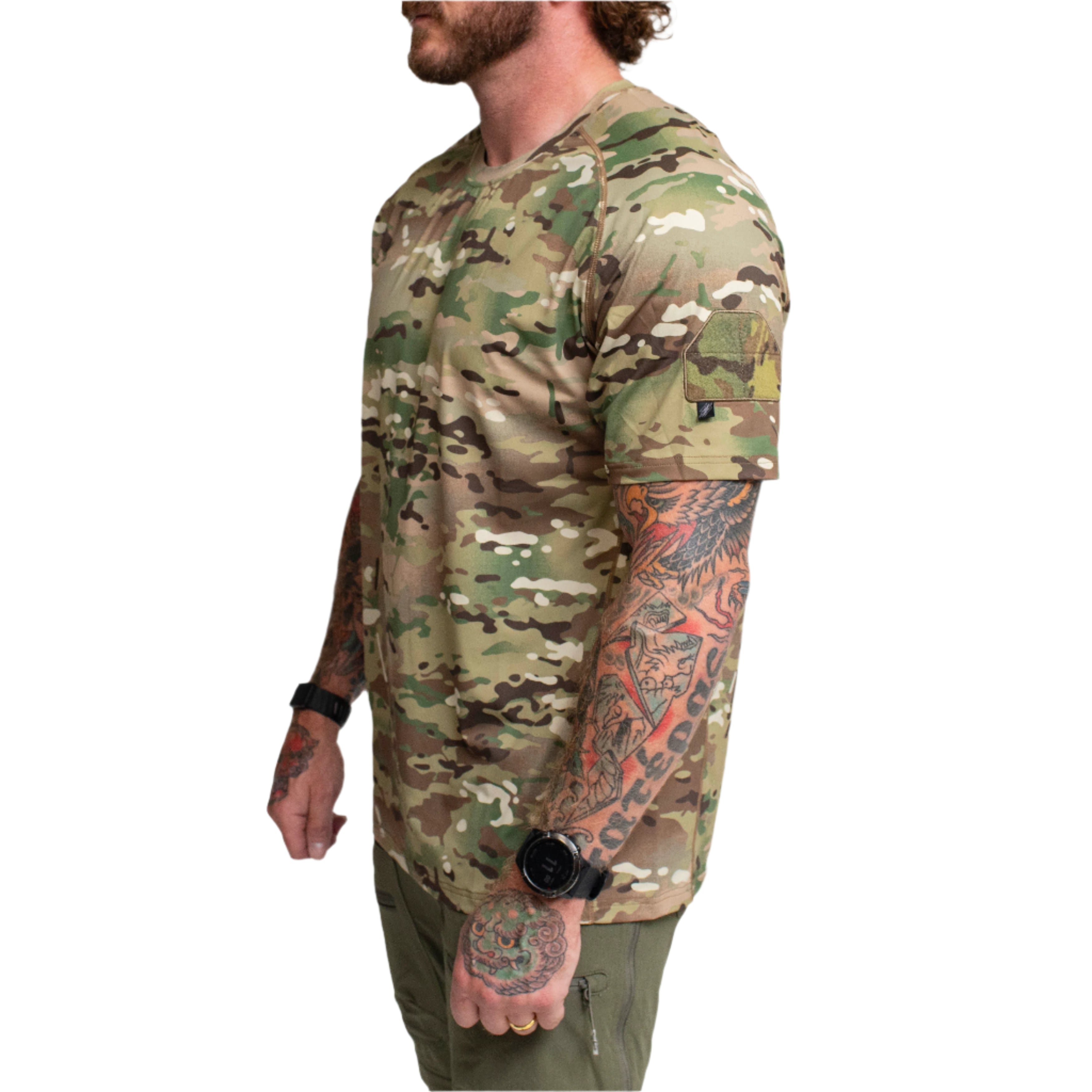Three quarter view of the TD Shooter Shirt MultiCam short sleeve version showing the athletic fit, 4 way stretch moisture wicking fabric, wrapped side panels, and MIL SPEC MultiCam loop bicep patch designed for range training and everyday tactical wear. Sold by Tactical Distributors for U.S. shooters and outdoor users.