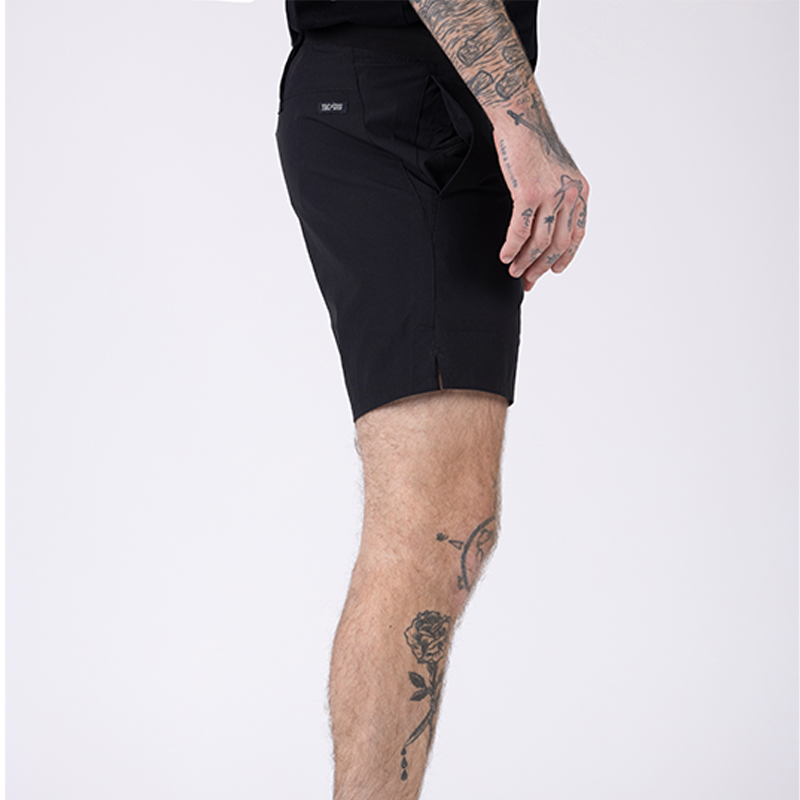 Side view of TD Workup Athletic Shorts in Black highlighting the subtle back branding detail and athletic cut. These tactical training shorts feature lightweight stretch ripstop fabric, a secure waistband, gusseted construction for freedom of movement, and EDC pocketing making them ideal for gym workouts, trail runs, and tactical fitness