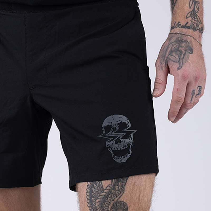 Close-up detail of the TD Workup Athletic Shorts showing the signature Workup skull logo and subtle branding on the lightweight stretch ripstop fabric. This tactical detail highlights the unique identity of these athletic training shorts designed for rugged workouts, running, and EDC-ready performance gear.