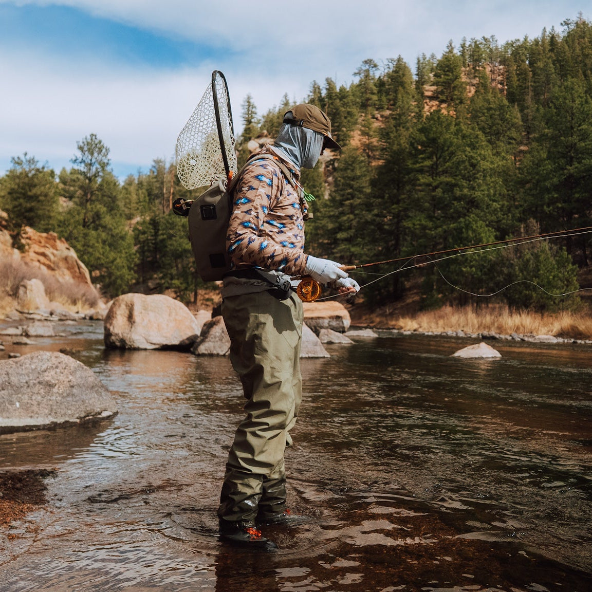 TD x Black Canyon Systems Southwest Tan hooded sun shirt worn while fly fishing, lightweight UPF 50 performance hoodie built for all day sun protection, moisture management, and unrestricted movement in outdoor backcountry environments