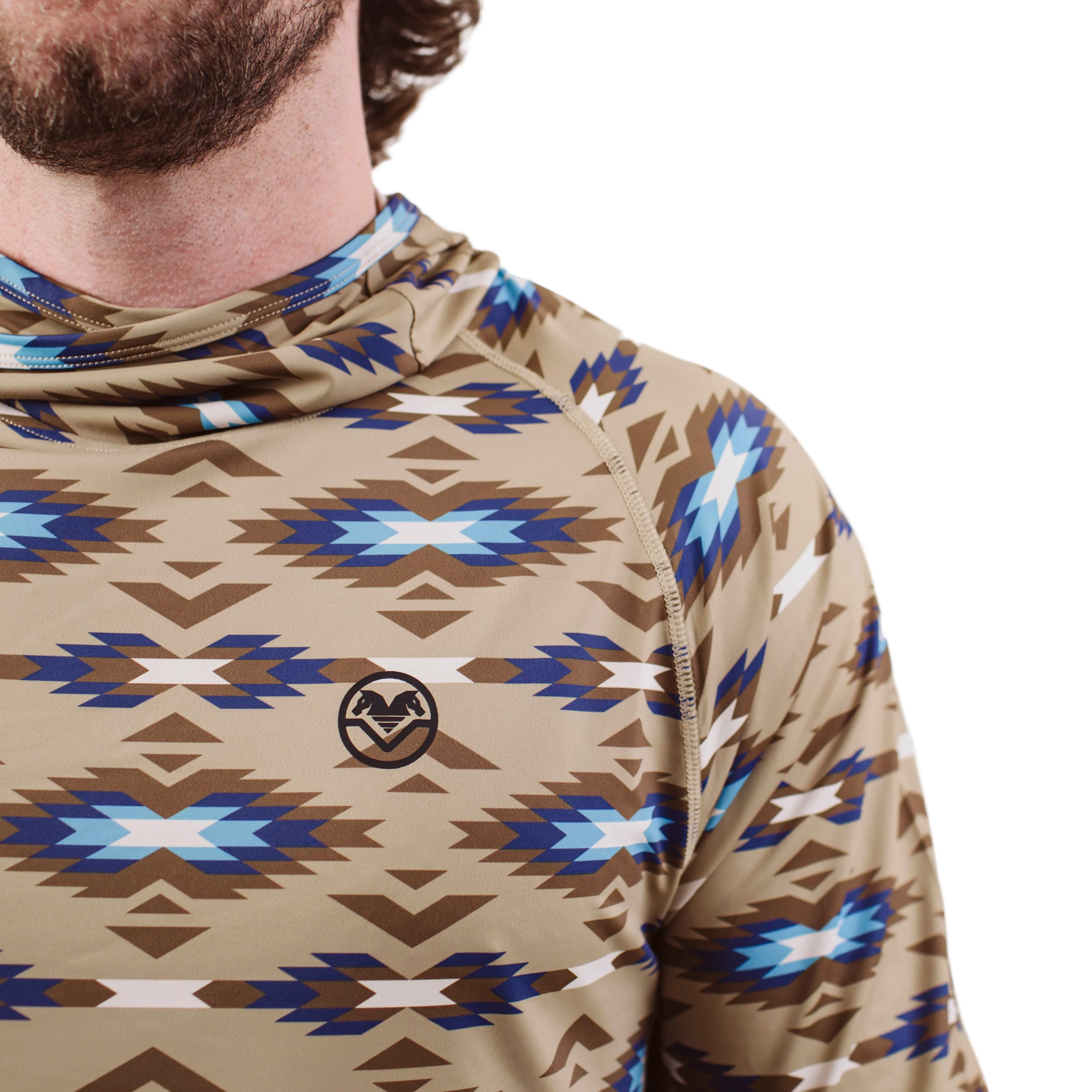 Close up of TD x Black Canyon Systems Southwest Tan sun hoodie showing front shoulder construction, flatlock seam detailing, and collaboration branding, lightweight tactical performance fabric designed for high mobility range training and hot climate operations