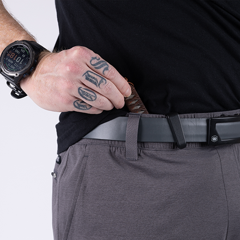 Close-up of TD Tactical EDC Joggers in Gunmetal Grey worn with a belt, demonstrating concealed carry compatibility and low-profile design for secure EDC loadout