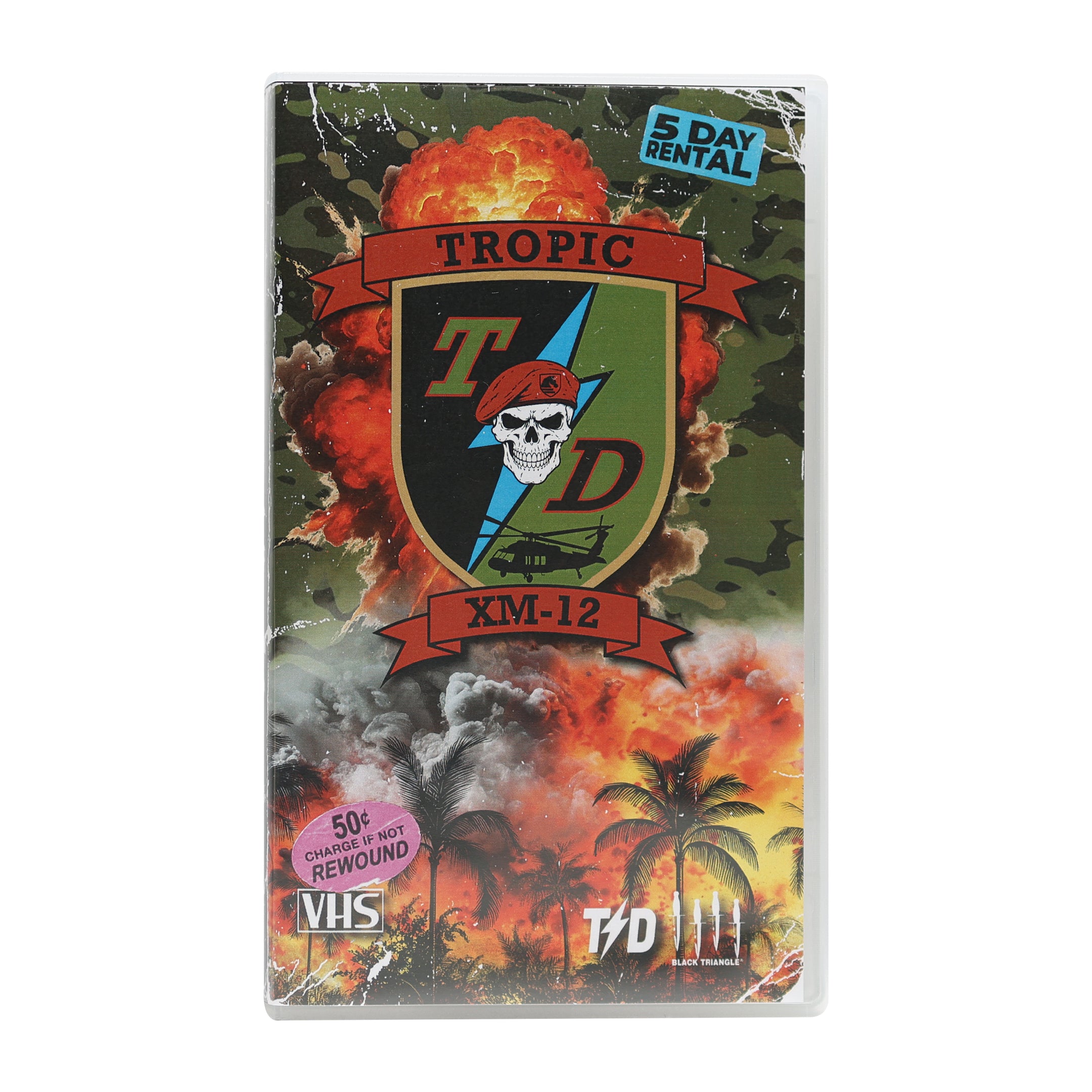 A VHS-style video case featuring tropical military-themed artwork with the text 'Tropic XM-12,' a skull and helmet emblem, palm trees, explosions, and a '5 Day Rental' label. The case is photographed on a plain white background.