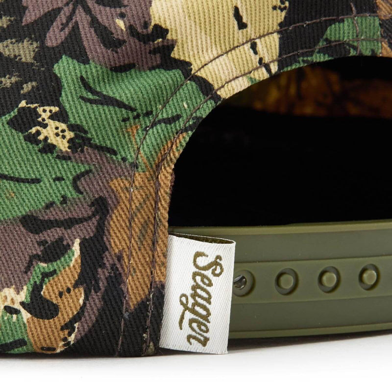 Camouflage cap with a visible brand label on a white background