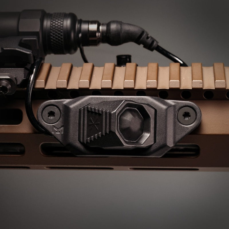 Alternate in-use view of the Unity AXON™ SL M-LOK Mounting Kit (Black) with AXON SL remote attached on an M-LOK handguard, showing secure low-profile fit and minimal footprint. Engineered for snag-free operation and reliable remote switching during dynamic tactical movement.