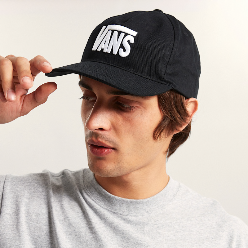 Person wearing a black Vans cap against a plain background