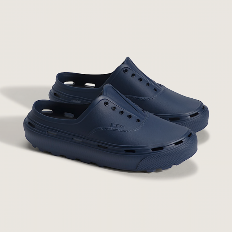 Pair of navy blue clogs on a light gray background