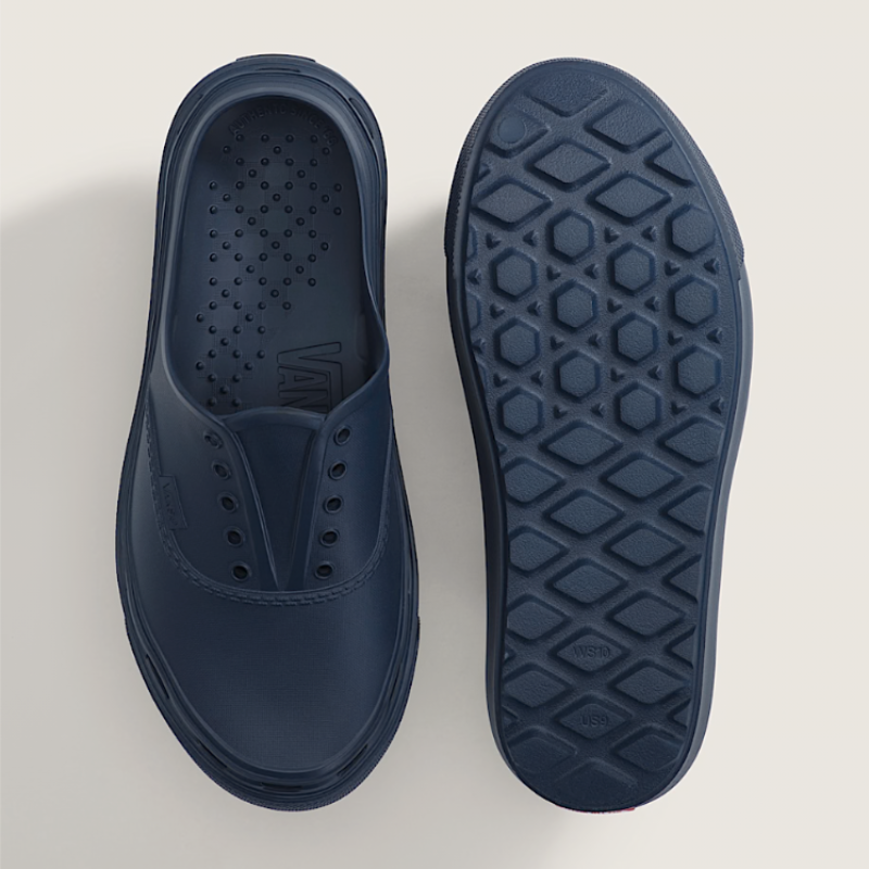 Navy blue slip-on shoe with textured sole on a light gray background