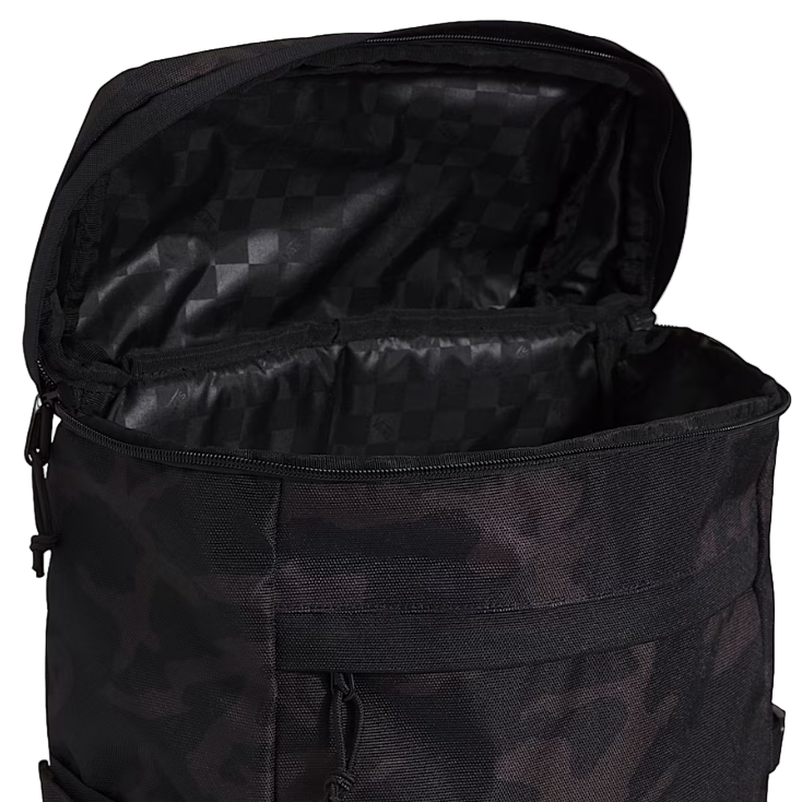 Top view of the Vans Omit Backpack unzipped showing the interior laptop sleeve and mesh zip pocket inside the rugged Cordura 28 liter main compartment designed for organized everyday and range use.