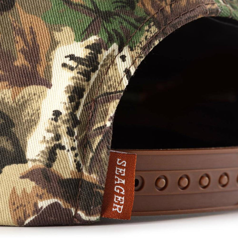 Camouflage cap with a visible 'Seager' brand tag on a white background