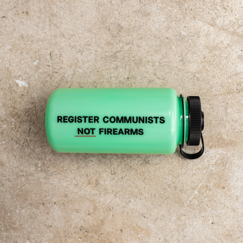 Glow in the dark water bottle with text on a beige surface