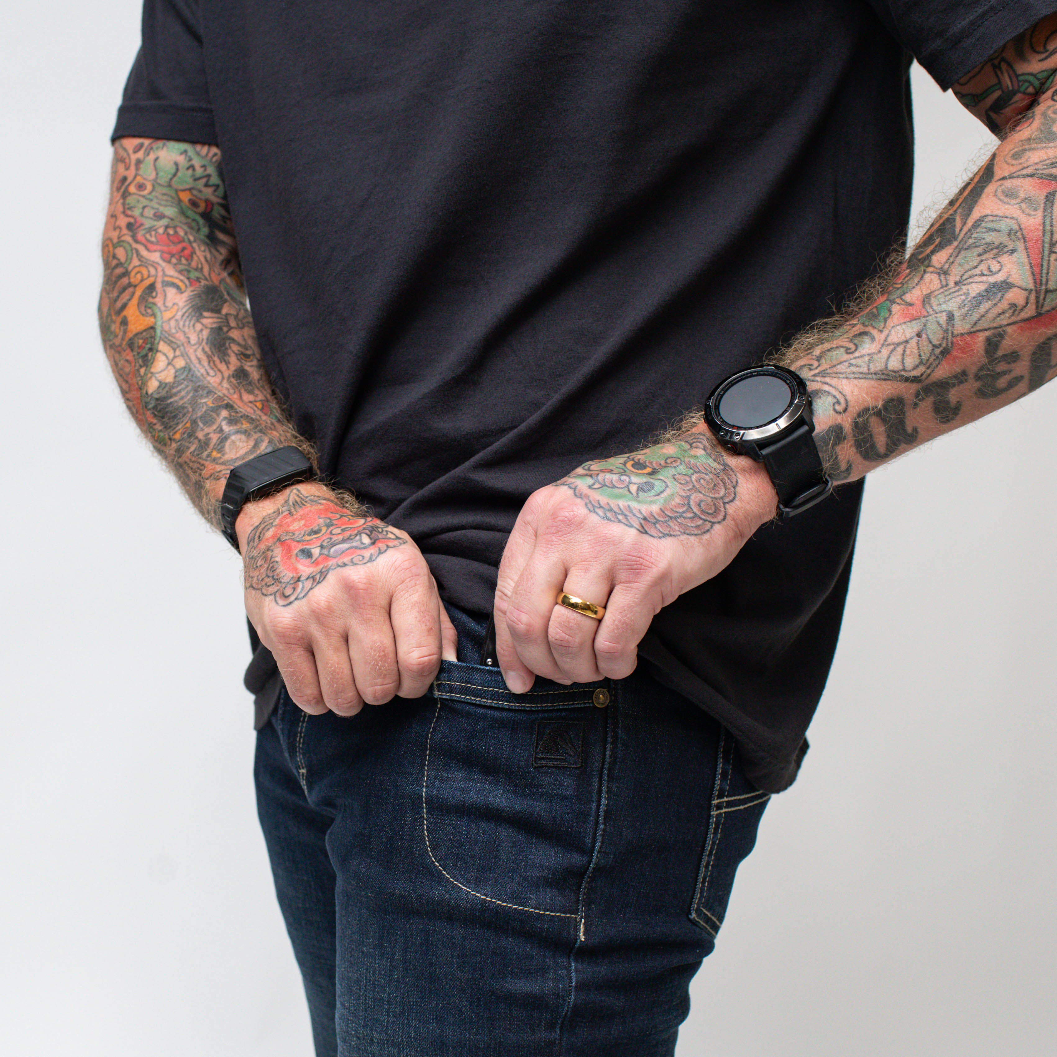 On body view of the TD McQuade Tactical Jeans showing the EDC pocket in use, highlighting the concealed carry friendly design and reinforced tactical pocket layout for knives, tools, and everyday carry gear.