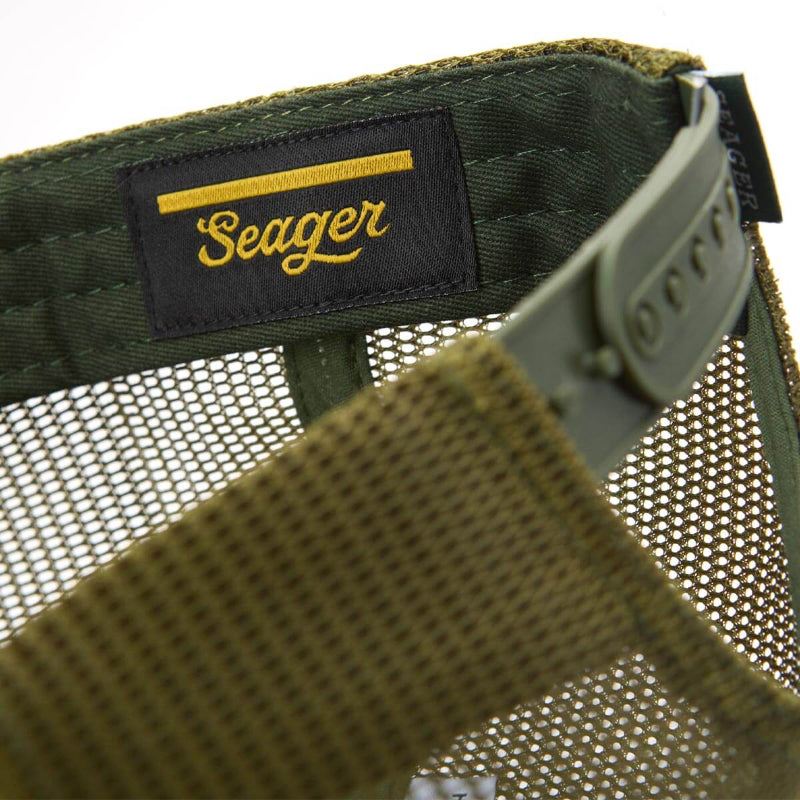 Close-up of a green mesh bag with a 'Seager' label on a white background