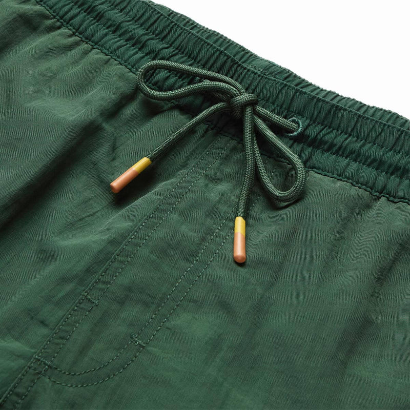 Close-up of green shorts with a drawstring on a white background