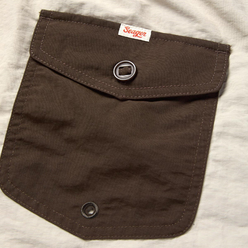 Brown pocket on a gray shirt with 'Seager' brand label.