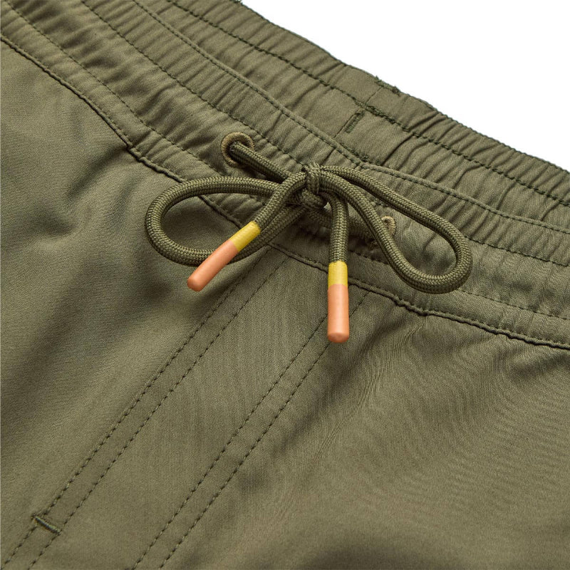 Close-up of green shorts with a drawstring on a matching background