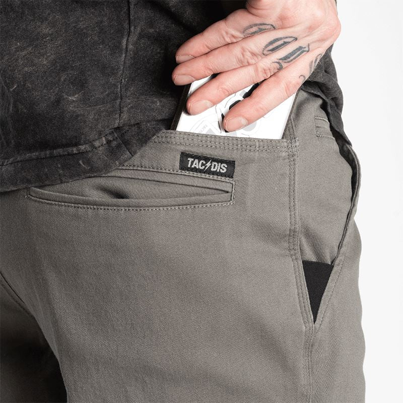 Close-up detail of Carlos Ray Chino Tactical EDC Pants highlighting hidden EDC pockets including concealed mag-ready back yoke pockets and discreet handcuff key pocket in the waistband, all integrated into a low-profile chino design for everyday tactical carry