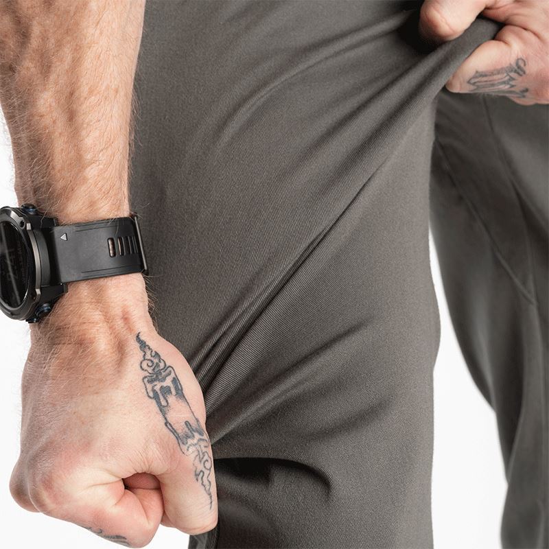 Image showing the Carlos Ray Chino Tactical EDC Pants being stretched to demonstrate the flexibility and comfort of the soft 4-way stretch cotton twill fabric, gusseted crotch for full range of motion, and low-profile tactical design with concealed EDC features