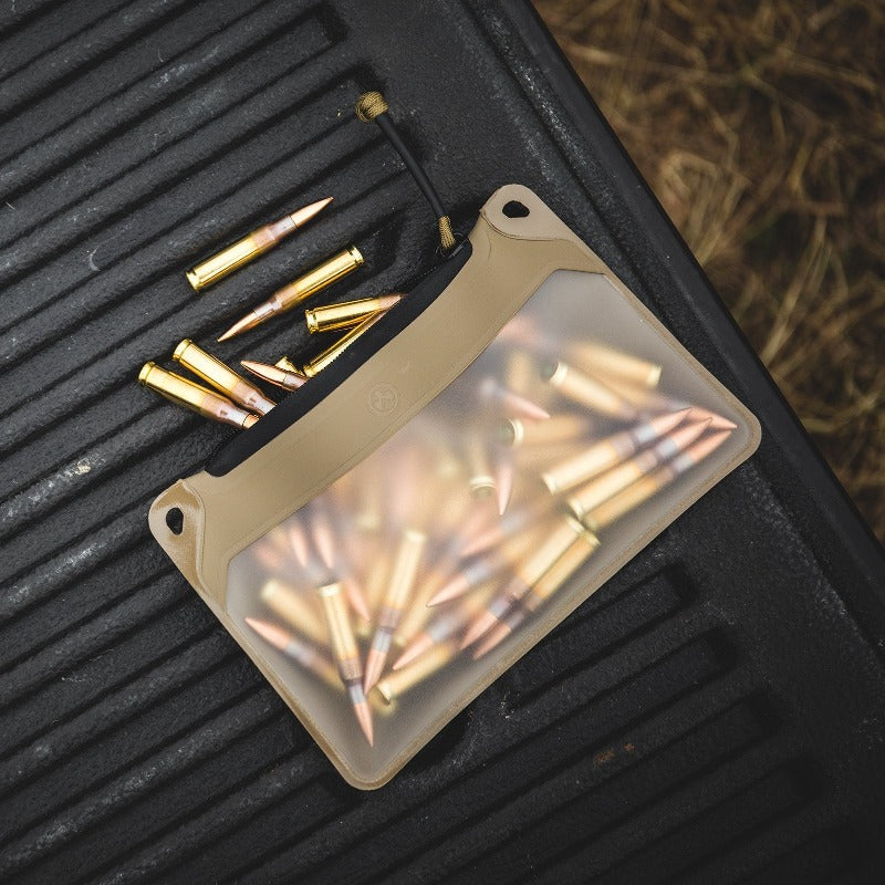 Magpul DAKA Window Pouch Small holding handgun ammunition, loaded magazines, and small range tools visible through clear window for organized range bag storage